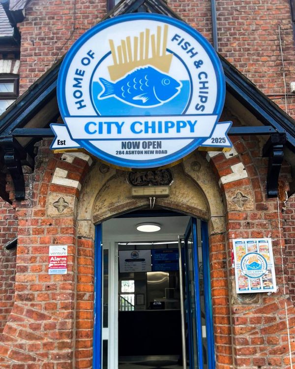 The entrance door of the city chippy takeaway in Manchester